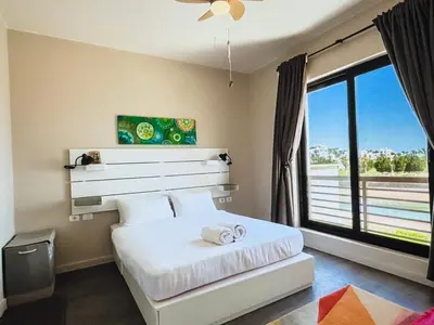 a bedroom with a bed and a large window at View and Location in Abu Tig Marina in Hurghada
