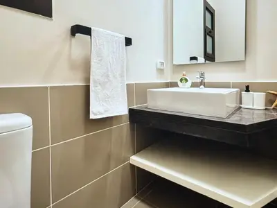 a bathroom with a white sink and a mirror at View and Location in Abu Tig Marina in Hurghada