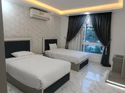 a hotel room with two beds and a window at Fanadir Bay in Hurghada