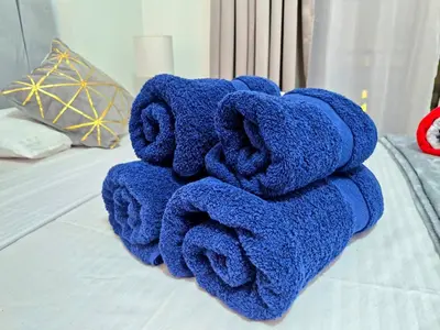 a pile of towels sitting on top of a bed at Gravity Sahl Hasheesh Not Egyptians in Hurghada