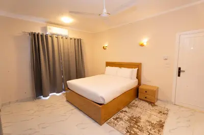 a small bedroom with a bed and a window at Villa Ramses in Luxor