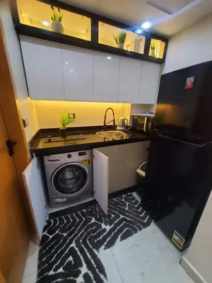 a small kitchen with a washing machine and a sink at Mirage bay aquapark 772B in Hurghada