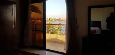 a mirror in a room with a view of a balcony at El BOB HOUSE in Luxor