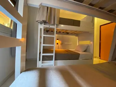 a bunk bed with a ladder in a bedroom at Jme Bunks Hostel in Aswān