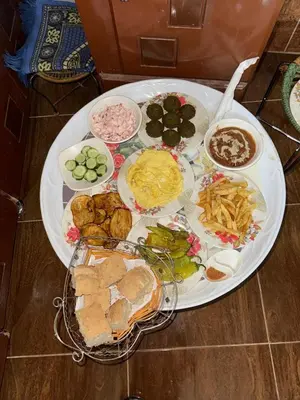 a large white plate of food on a table at MERIT Guest House in Aswan