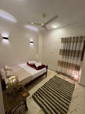 a bedroom with a bed and a rug and a ceiling at MERIT Guest House in Aswan
