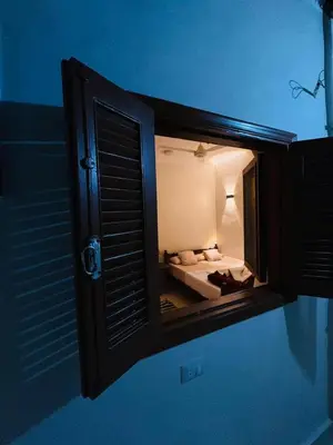 a small room with a bed in a window at MERIT Guest House in Aswan