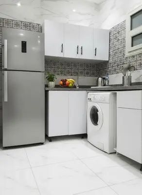 a kitchen with white cabinets and a washer and dryer at Hurghada luxury apartment sea view 5 in Hurghada