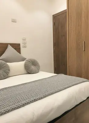 a bed with two pillows on top of it at Hurghada luxury apartment sea view 5 in Hurghada