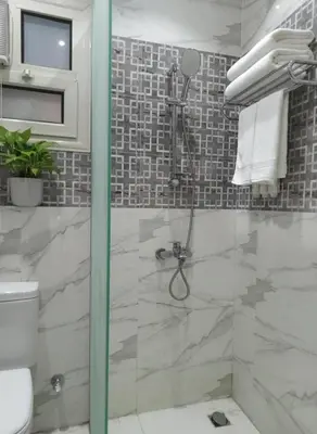 a bathroom with a shower with a glass door at Hurghada luxury apartment sea view in Hurghada