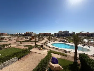 a view of a swimming pool at a resort at Bright Kamaran 2BR | Lofty Ceilings & Pool Access in Hurghada