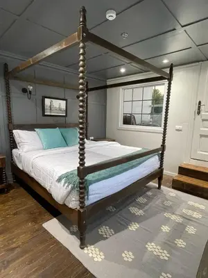 a bedroom with a canopy bed in a room at Miss Fatima Dahabiya-Nile Cruise 4 night sailing-Includes English speaking Guide and site seeing -All inclusive excluding alcoholic beverages in Luxor