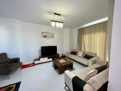 a living room with two couches and a tv at 4BR Penthouse, Lagoon View, Swanlake El Gouna in Hurghada