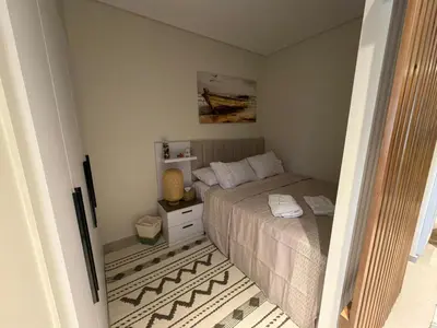 a small bedroom with a bed and a table at Spacious Gouna Studio | Pool Access + Terrace in Hurghada