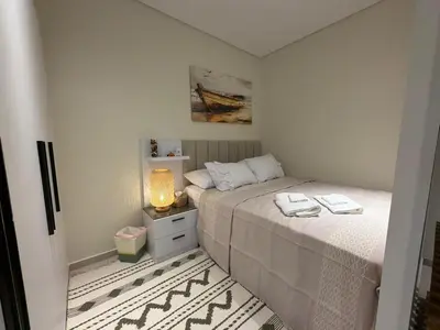 a bedroom with two beds and a lamp in it at Spacious Gouna Studio | Pool Access + Terrace in Hurghada