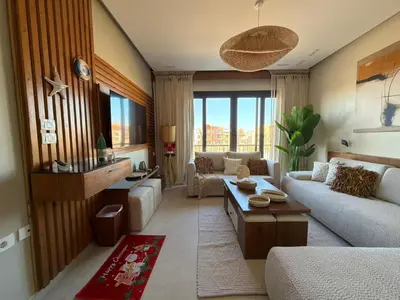 a living room with a couch and a table at Spacious Gouna Studio | Pool Access + Terrace in Hurghada