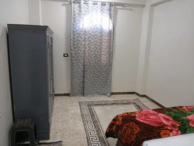 a bedroom with a shower and a bed in a room at Rafe Guest House in Luxor