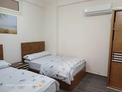 a hotel room with two beds and a window at Suncare America in Hurghada
