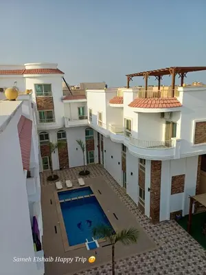 an aerial view of a building with a swimming pool at Suncare America in Hurghada