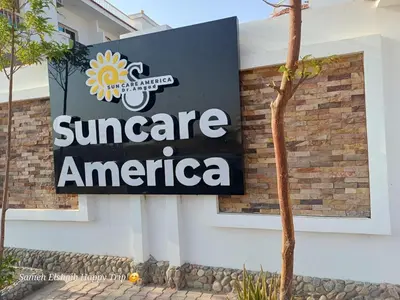 a sign on the side of a building at Suncare America in Hurghada