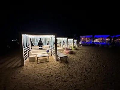 a row of beds on the beach at night at Selena Bay Resort - VIP apartment with Private Beach Area in Hurghada