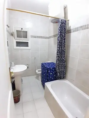 a bathroom with a tub and a toilet and a sink at Fayrouz Compound in Hurghada