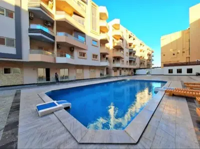 a large swimming pool in the middle of a building at La bella resort touristic walkway hurghada in Hurghada