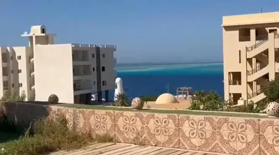 a view of two buildings and the ocean at Sea View luxury chalet in Hurghada