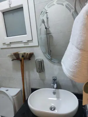 a bathroom with a sink and a toilet and a mirror at Solitaire in Hurghada