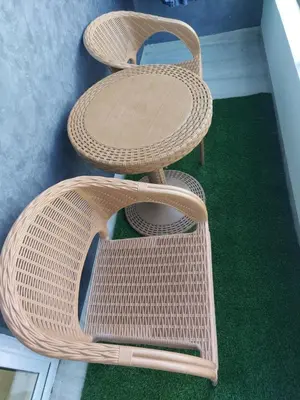 two wicker chairs sitting on a green floor at Solitaire in Hurghada