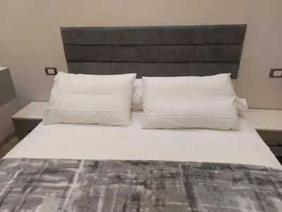 a bed with two pillows on top of it at Solitaire in Hurghada