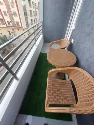 a balcony with two chairs and a table and grass at Solitaire in Hurghada