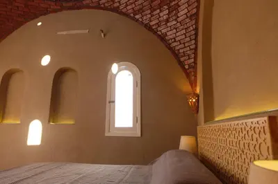 a bedroom with a bed and a window at Mountian View Domes in Al Aqālitah