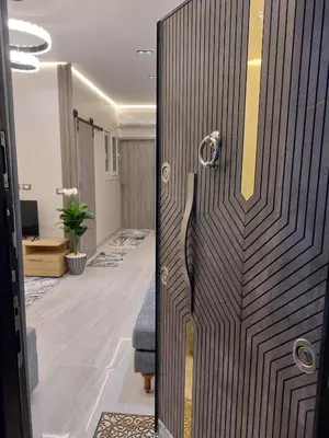 a wooden door in a room with a living room at solitaire in Hurghada