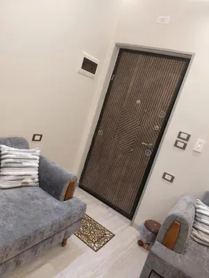 a room with two couches and a wooden door at solitaire in Hurghada