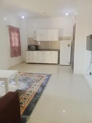 a living room with a kitchen with a refrigerator at Cozy 2-Bedroom Apartment Ramla, West Bank, Luxor in Luxor