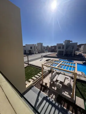 a view of a pool from the balcony of a building at The Best House in Makadi in Hurghada