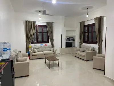 a living room with couches and a table in it at Durrat al-Nahr in Luxor
