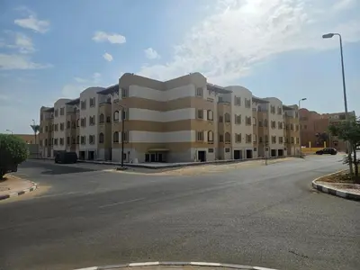 an empty street in front of a large building at Modern apartment with pool view in Port Ghalib in Port Ghalib