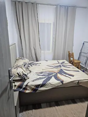 an unmade bed in a bedroom with a window at Modern apartment with pool view in Port Ghalib in Port Ghalib