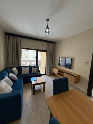 a living room with a blue couch and a table at Casa Bonita 2307 in Hurghada