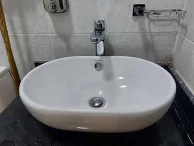 a white sink in a bathroom with a fosset at سولتير in Hurghada