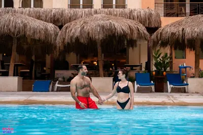 a man and woman standing in a swimming pool at Contenintal Rosa Boho Aquapark Hotel 3 Stars in Hurghada