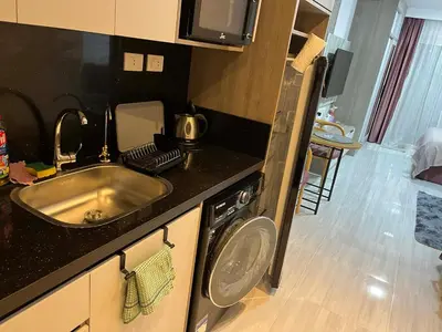 a kitchen with a sink and a washing machine at rezort Al Hambra, rezort Princess in Hurghada