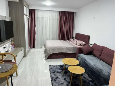 a living room with a couch and a bed at rezort Al Hambra, rezort Princess in Hurghada