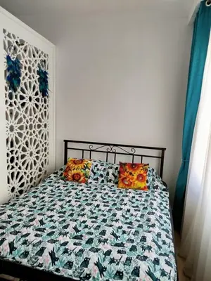 a bed with colorful pillows on it in a bedroom at Sheraton Plaza 319 in Hurghada