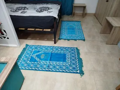 a room with two blue rugs on the floor at Sheraton Plaza 319 in Hurghada
