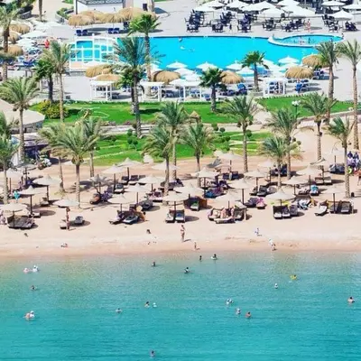an aerial view of a beach with people in the water at Mirage Bay Resort Aquapark Cap Ahmed Suite in Hurghada