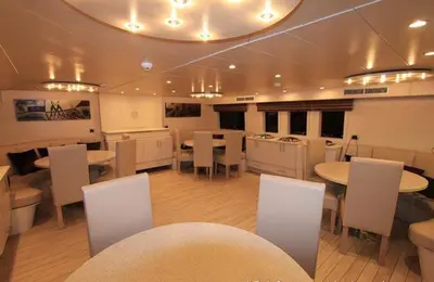 a large room with tables and white chairs and tablesktop at Yacht Aml-Hayaty in Hurghada