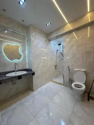 a bathroom with a toilet and a sink at شقه لك ب الكامل فندقي in Safaga